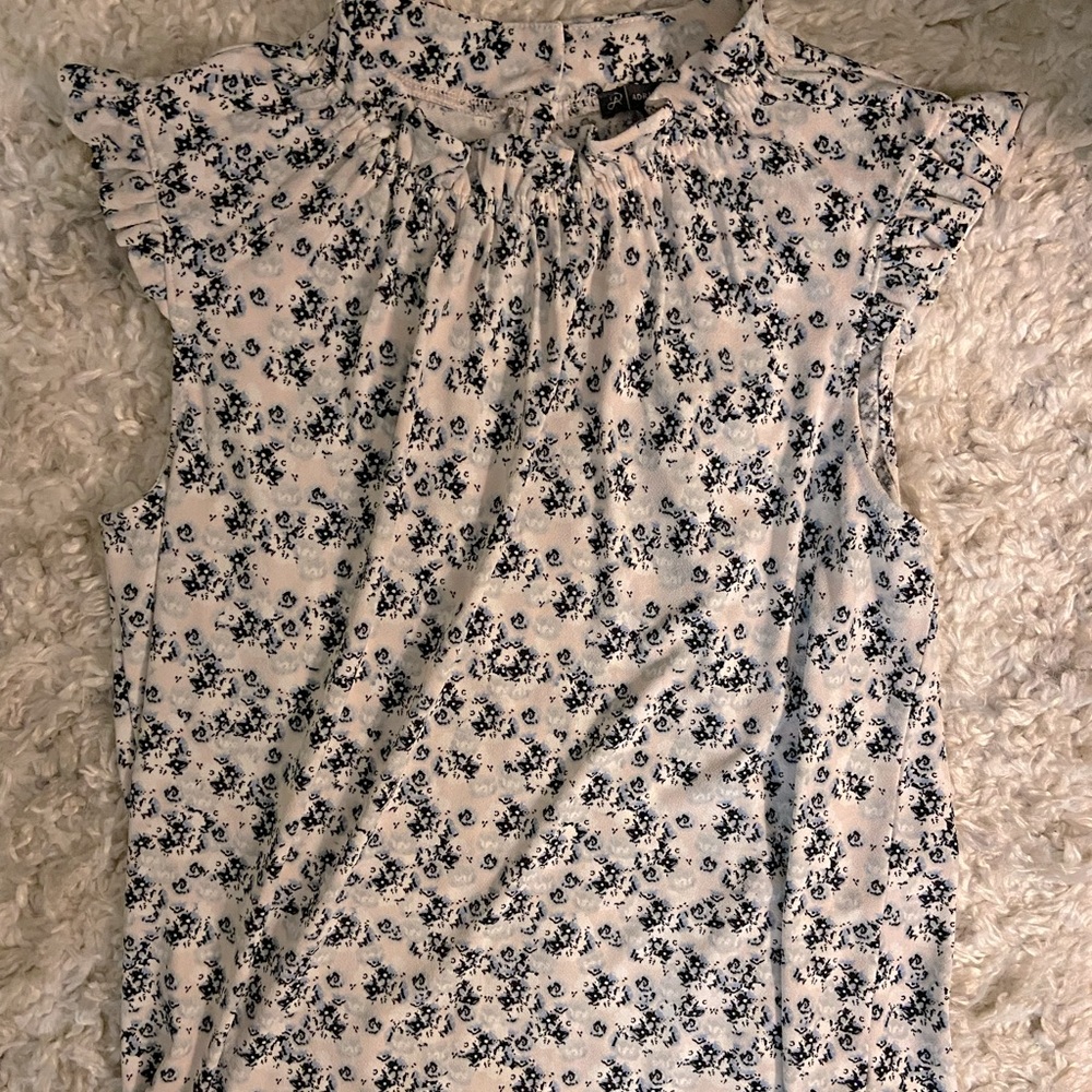 Pale pink, sleeveless blouse with floral design